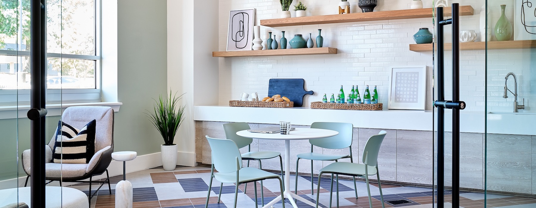a room with a table chairs and a shelf with objects on it