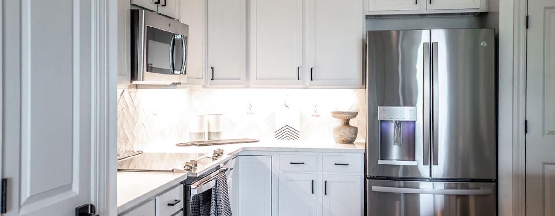 a kitchen with white cabinets