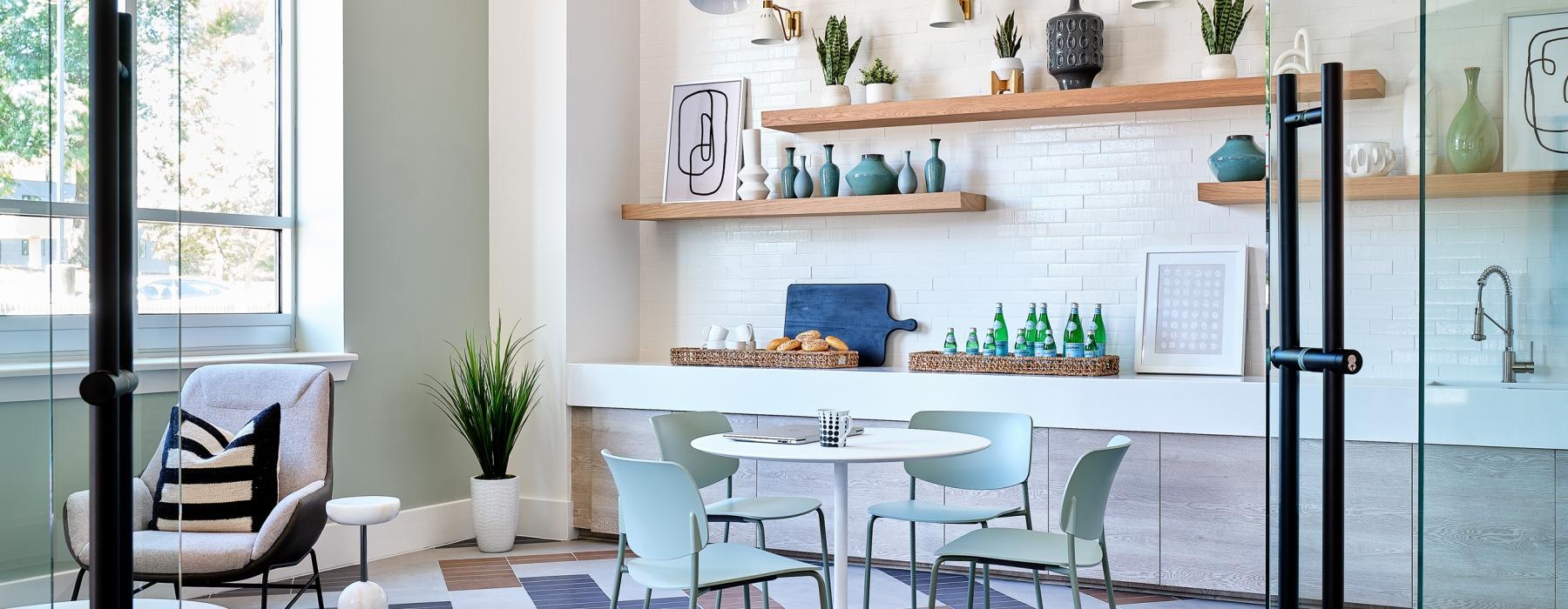 a room with a table chairs and a shelf with objects on it